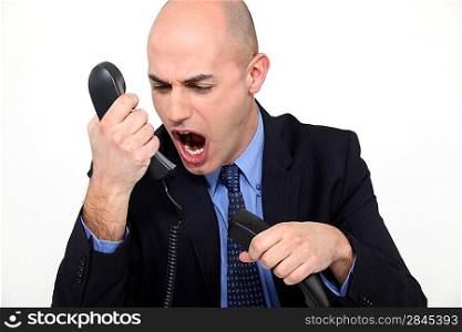 man shouting angrily in receiver
