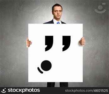 Man show banner with upset smiley. Businessman hold white board with sad face emoticon