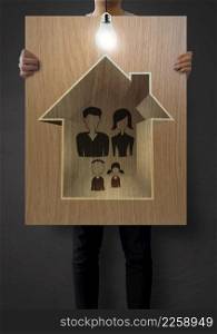 man show hand draw family and house on wooden poster as insurance concept