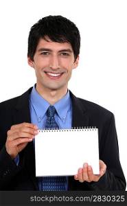 Man showing blank page on a notebook