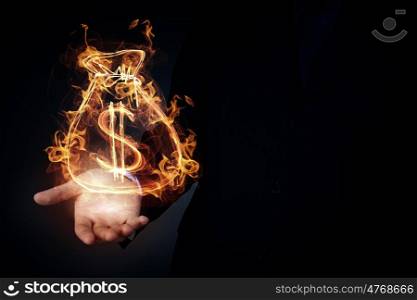 Man showing dollar symbol. Burning dollar sign in businessman palm on dark background