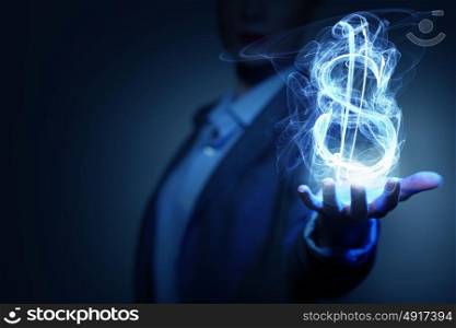 Man showing dollar symbol. Burning dollar sign in businesswoman palm on dark background