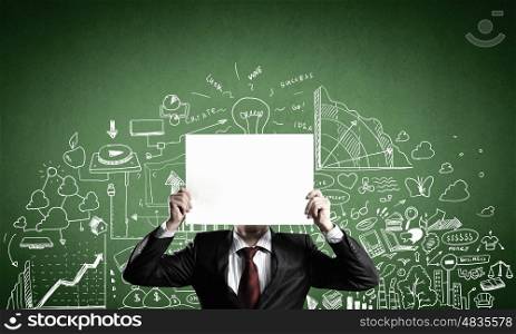 Man showing paper sheet. Businessman hiding his face behind paper list