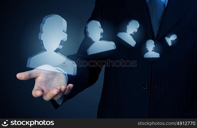 Man showing people icons. Close up of male hand holding people figures in palm