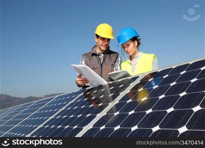 Man showing solar panels technology to student girl