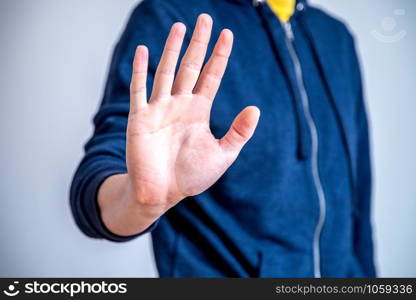 Man showing stop gesture, close up of the hand