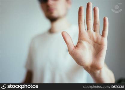 Man showing stop gesture, close up of the hand