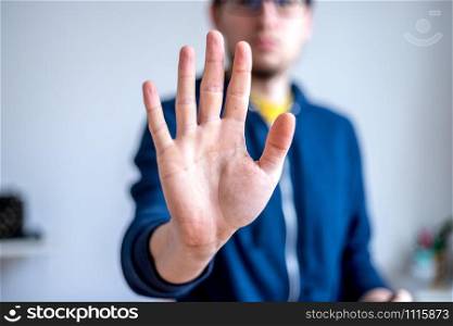 Man showing stop gesture, close up of the hand