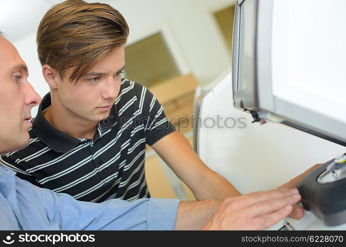 man showing teen technological device