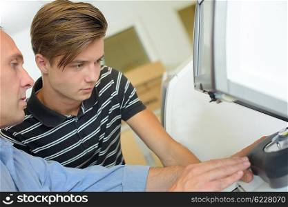 man showing teen technological device