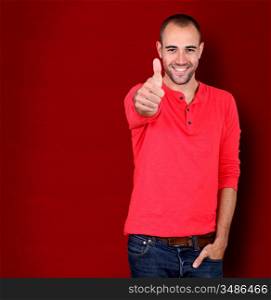 Man showing thumb up on red background