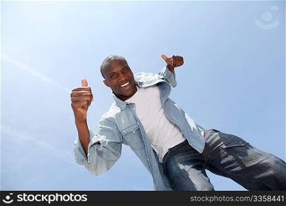 Man showing thumbs up with blue sky