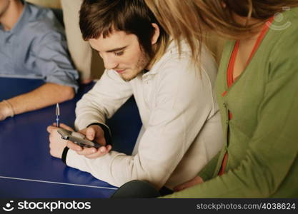 Man showing woman his mobile phone