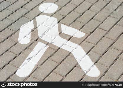 man sign white color on the sidewalk