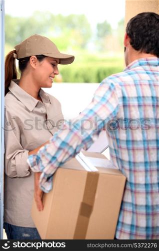 Man signing for a parcel at the front door
