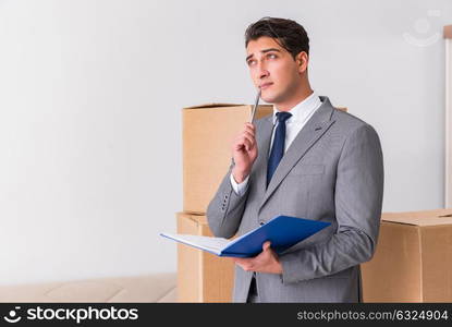 Man signing for the delivery of boxes