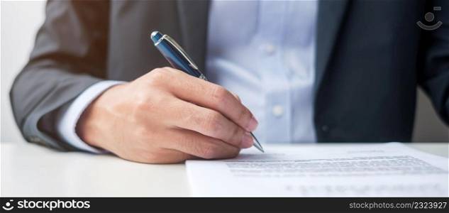 man signing on contract documents after reading, man holding pen and approve on business report. Contract agreement, law and deal concepts