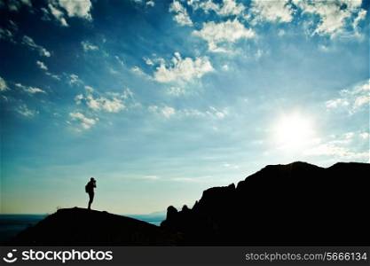 Man silhouette at sunset in mountains. Crimea landscape