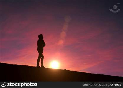 man silhouette in the mountain with a beautiful sunset background