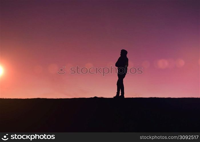 man silhouette trekking in the mountain with a beautiful sunset