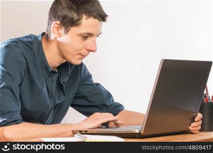 Man siting at desk working in a laptop pc