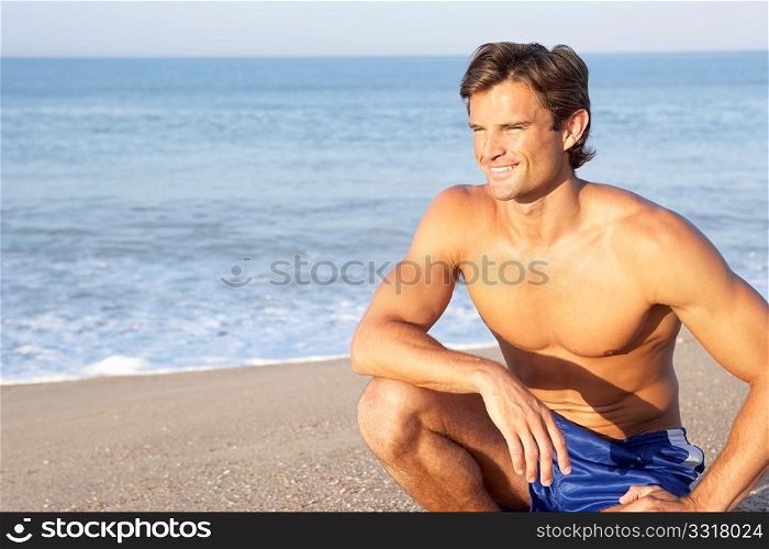 Man sits on beach relaxing