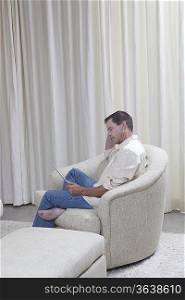 Man sits reading a digital book