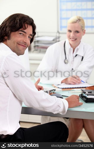Man sitting at a doctor&rsquo;s desk