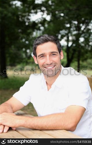 Man sitting at a table in a park