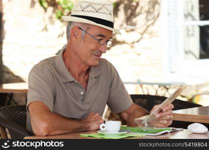 Man sitting at an outdoor cafe table