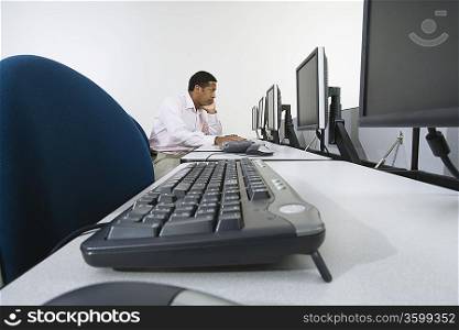 Man sitting at desk in front of computer