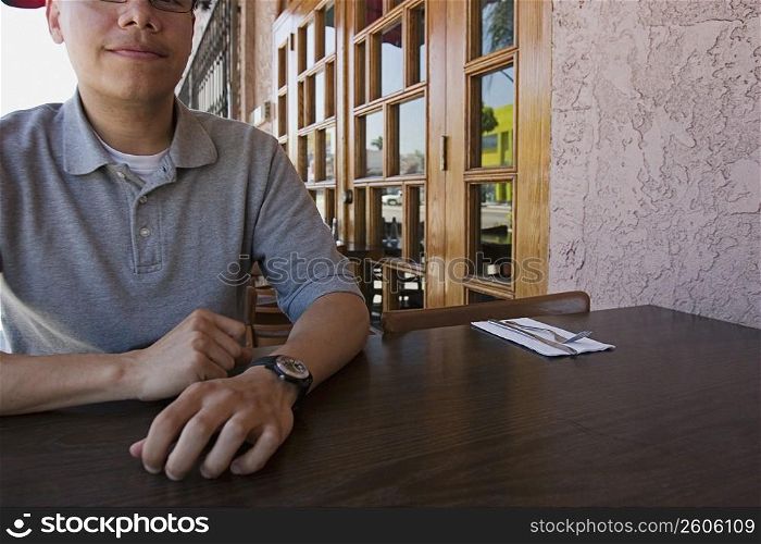 Man sitting at outdoor restaurant