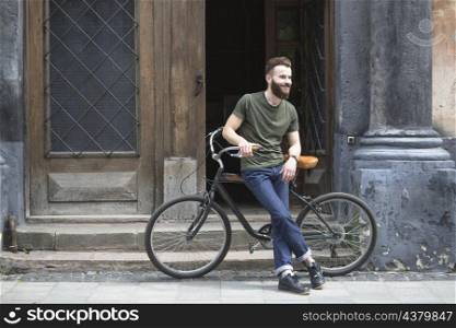 man sitting bicycle front open door