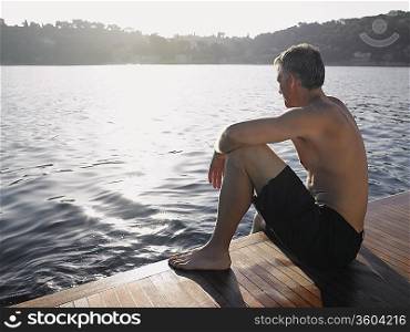 Man Sitting by Water