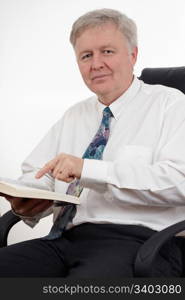 Man sitting in an armchair and showing something in the Bible