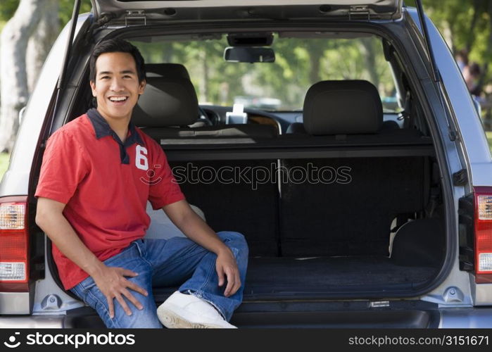 Man sitting in back of van smiling