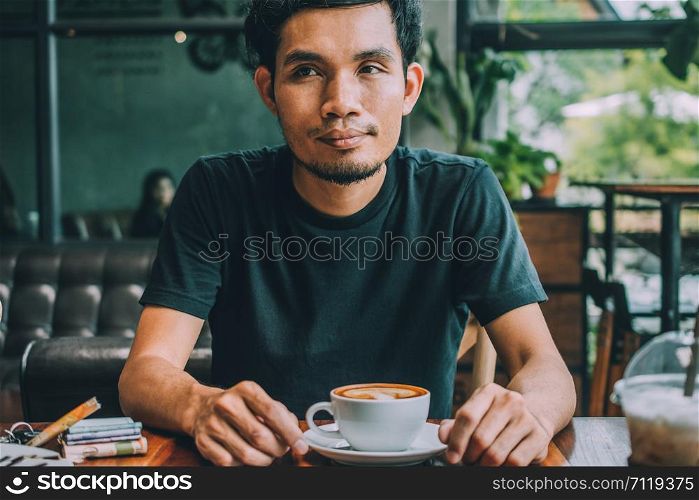 Man sitting in coffee shop for drink in coffee time