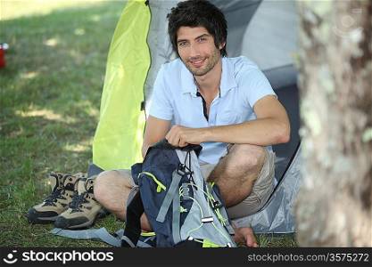 Man sitting in front of his tent