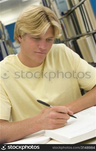 Man sitting in library studying