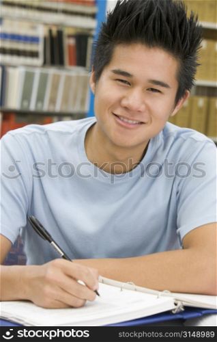 Man sitting in library studying