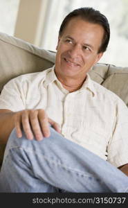 Man sitting in living room smiling