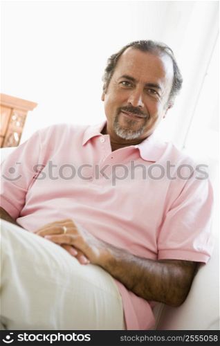 Man sitting in living room smiling (high key)