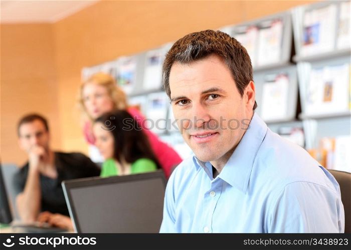 Man sitting in office in front of laptop computer