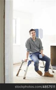Man Sitting In Property Being Rennovated