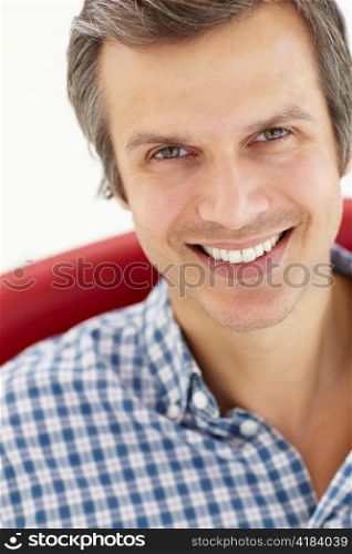 Man sitting in red chair