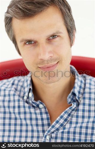 Man sitting in red chair