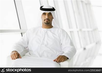 Man sitting indoors (high key/selective focus)