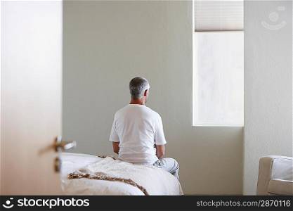 Man Sitting on Bed