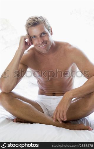 Man sitting on bed smiling