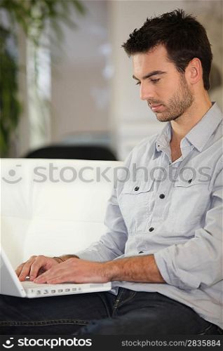 Man sitting on couch with computer